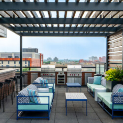 outdoor rooftop grilling station with lounge chairs